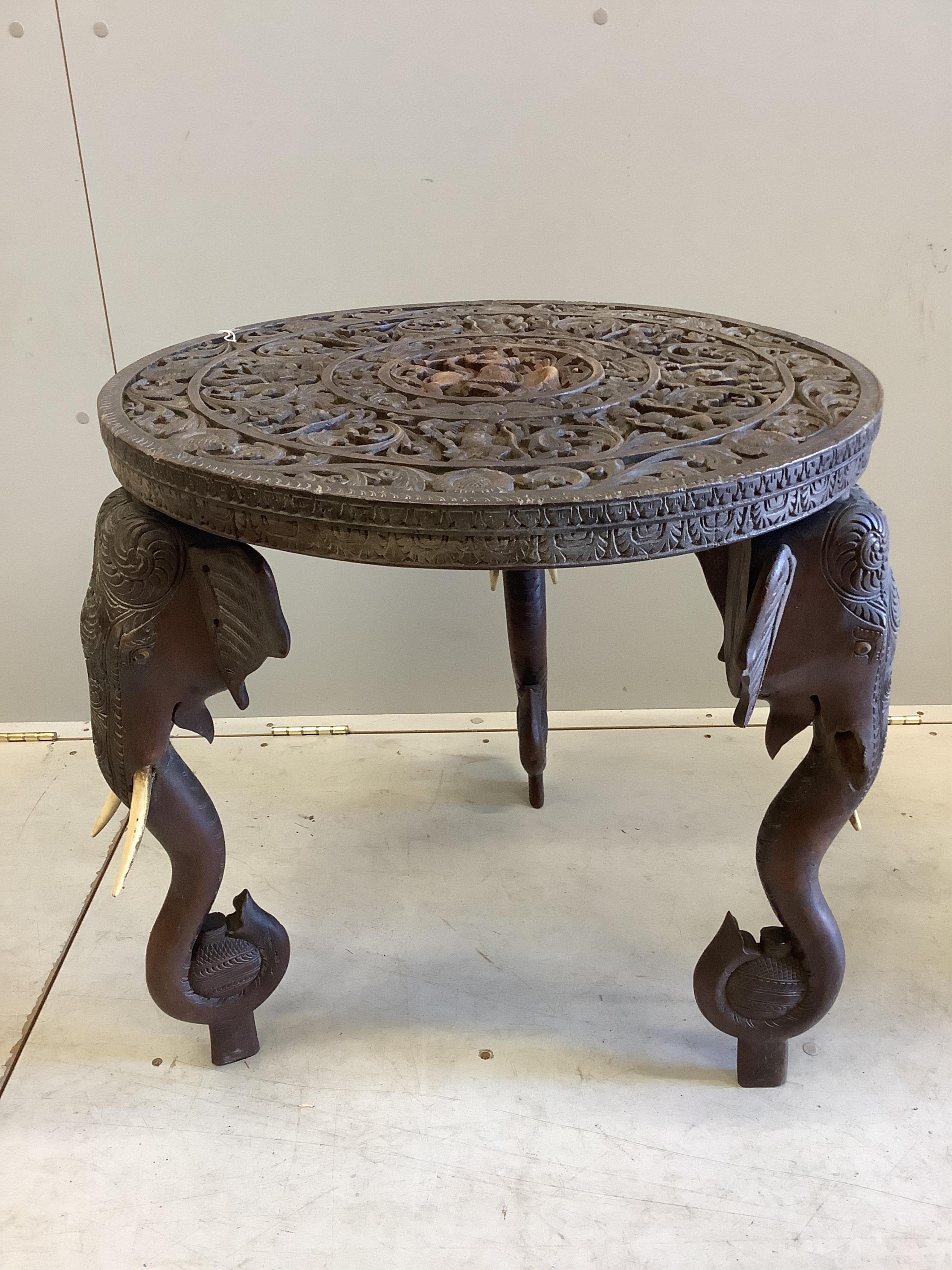 A circular Indian carved hardwood elephant's leg occasional table, diameter 61cm, height 63cm. CITES Submission reference, 8ZTMP59B